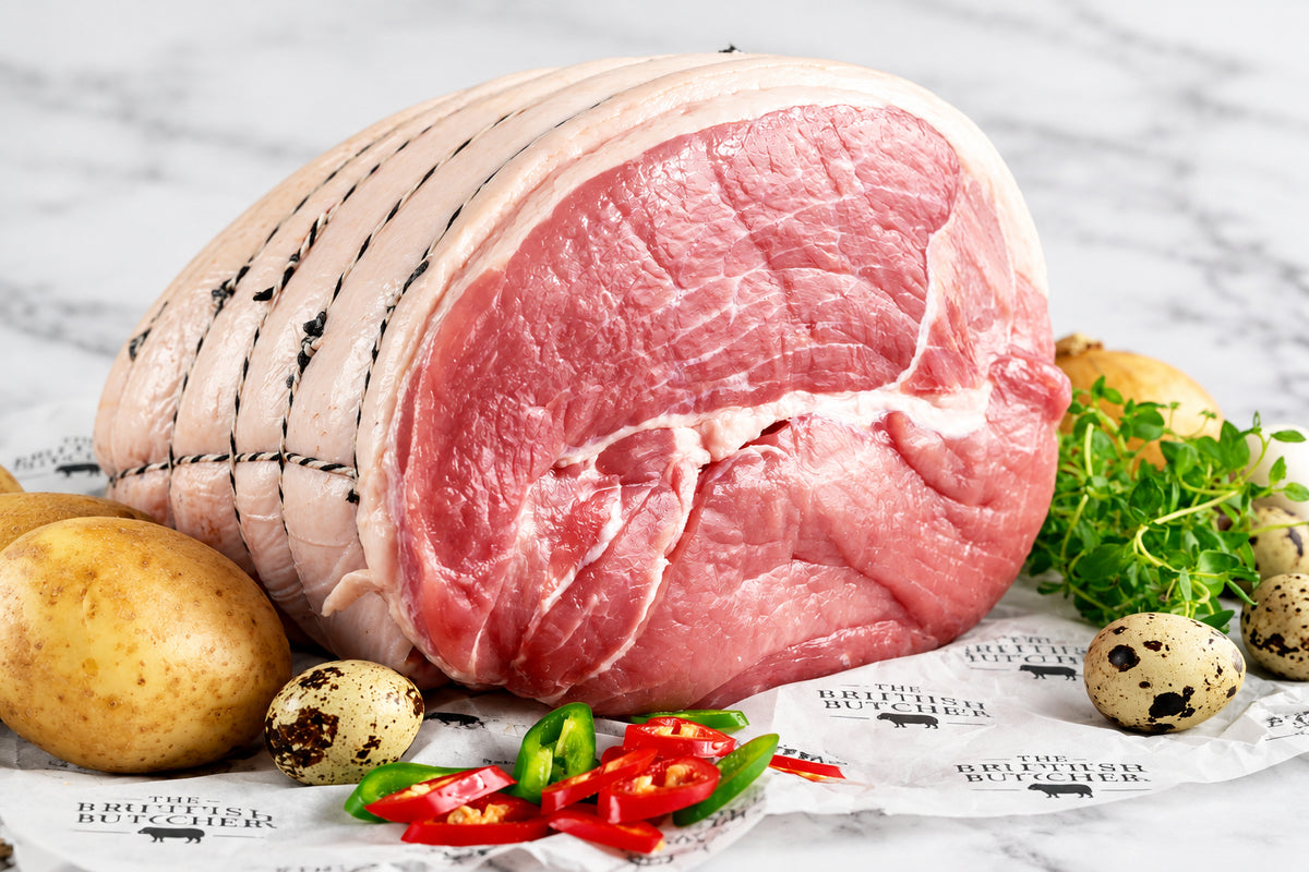 raw gammon horseshoe tied displayed on greaseproof paper with vegetables