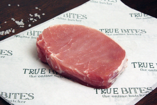a stack of bacon medallions pictured on true bites branded greaseproof paper