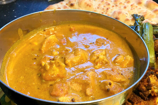 cooked chicken curry in a stainless steel bowl