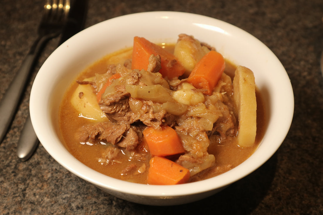 home made beef casserole with potatoes served in a white bowl 