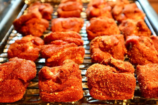 a tray of pork belly cubes covered in matts original pork dry rub