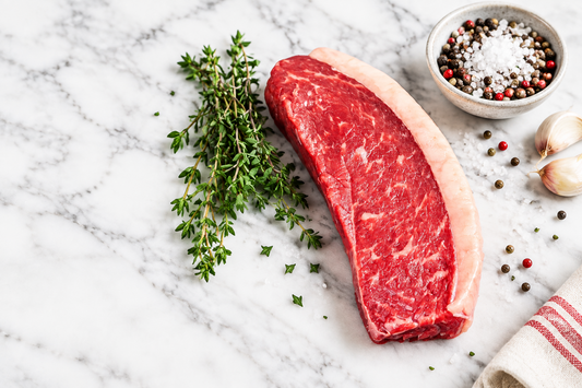 raw picanha steak on a marble counter top