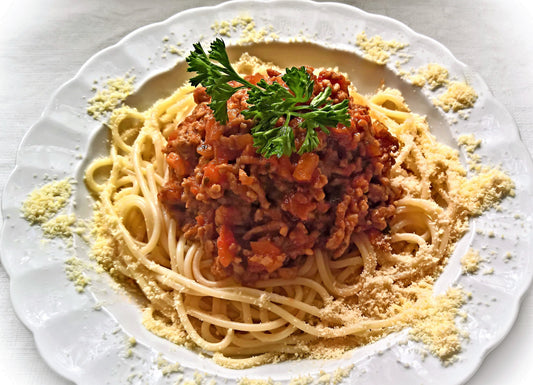 spaghetti bolognese photographed on a white plate