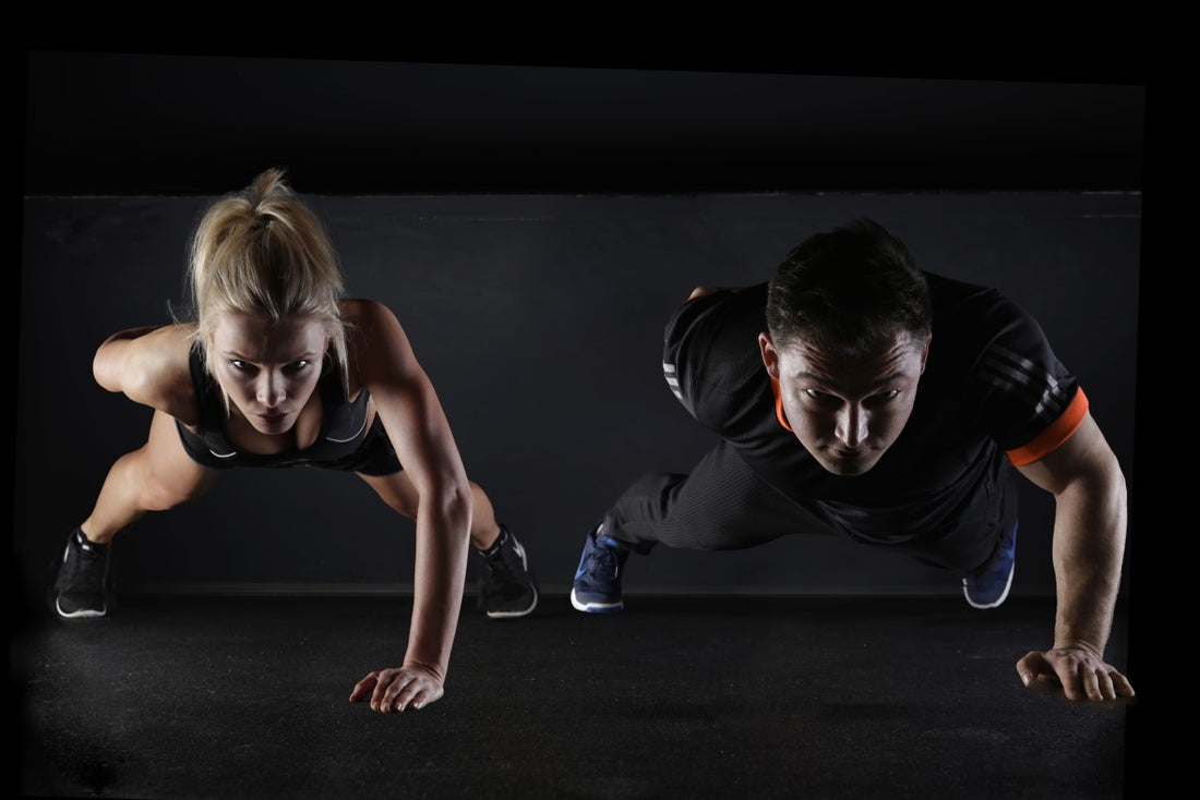 a man and a woman doing one handed press ups simultaneously 
