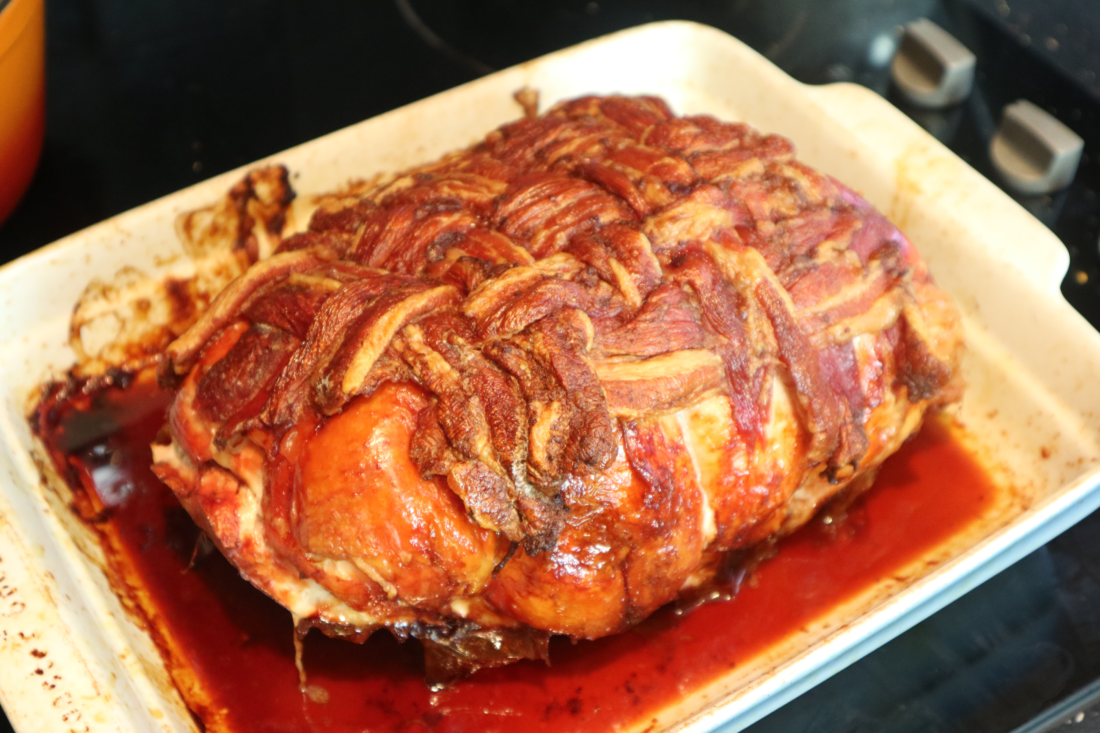 cooked turkey butterfly with a streaky bacon lattice draped over the top