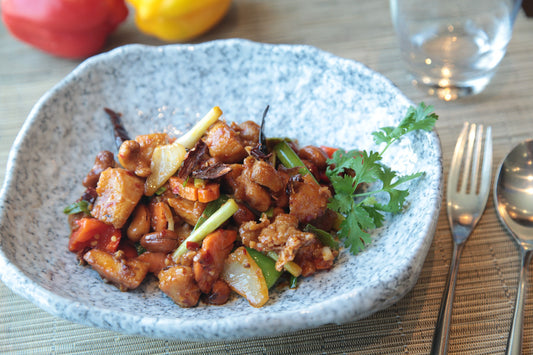 sweet and sour chicken presented in a stoneware dish