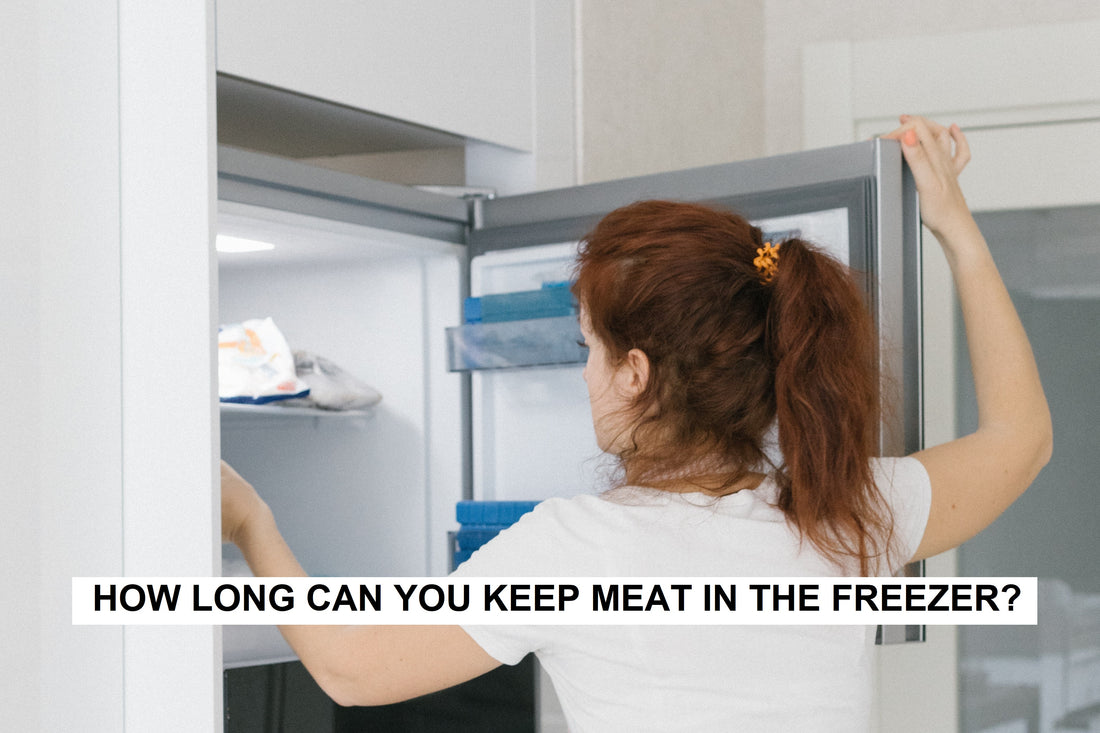woman opening freezer open and inspecting contents