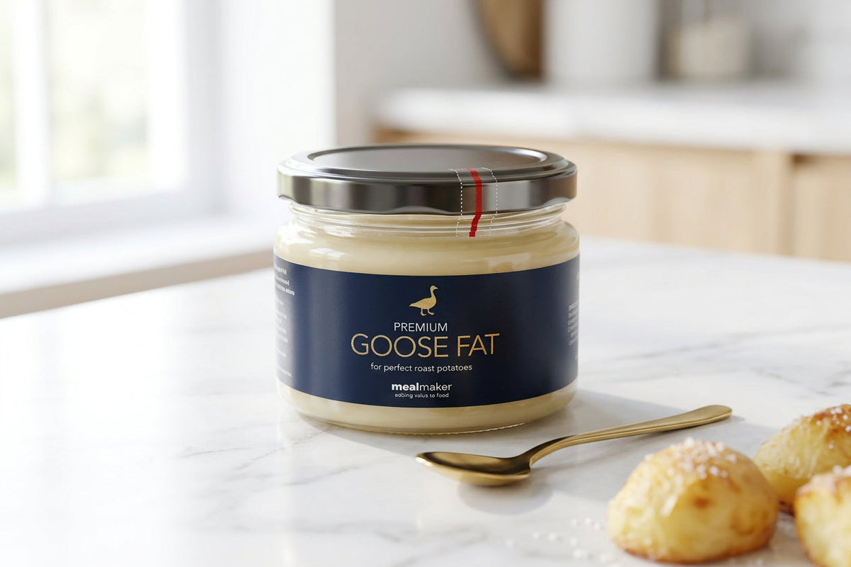goose fat in a glass jar on a white surface.