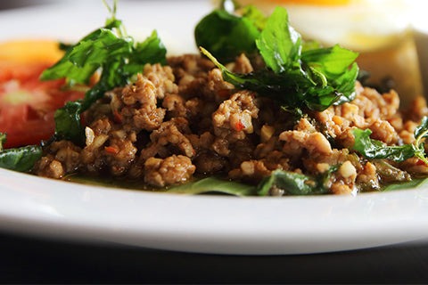 fried pork mince served with green leaves