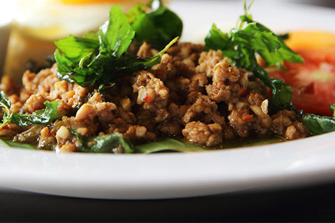 fried pork mince served with green leaves