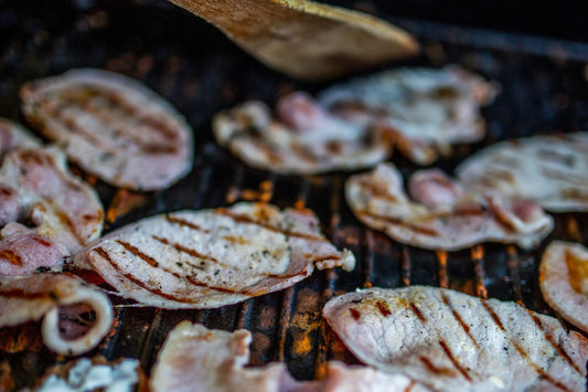 back bacon cooking on a cast iron griddle