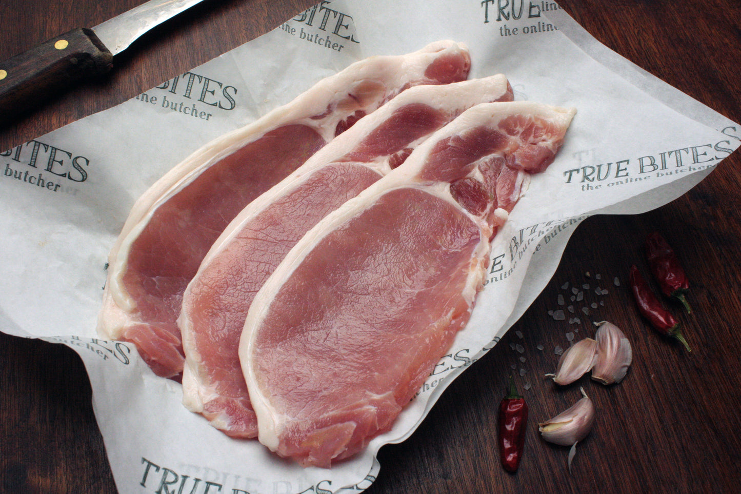 rashers of back bacon displayed on true bites branded greaseproof paper