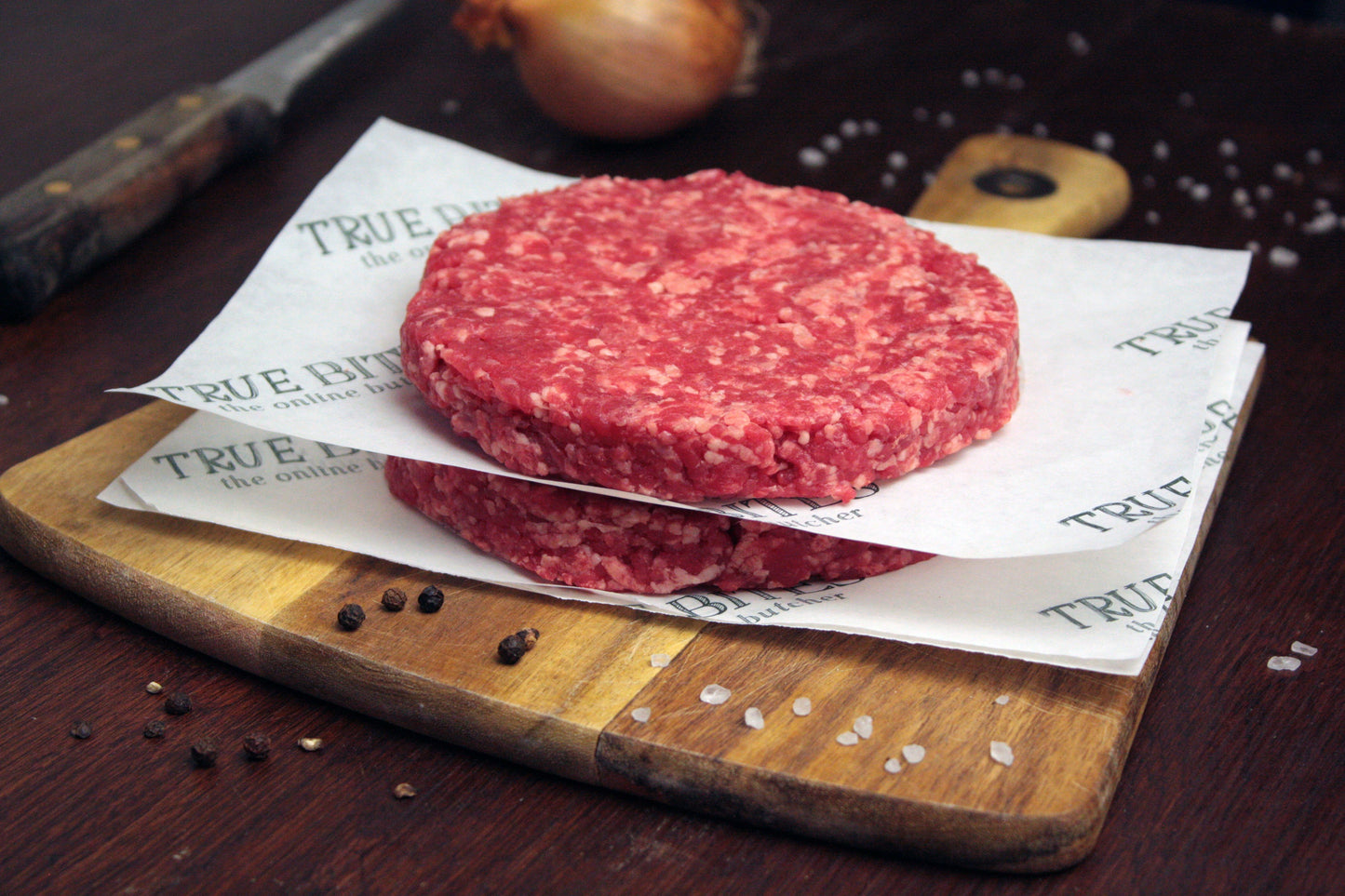 4oz beef burgers displayed on true bites greaseproof paper