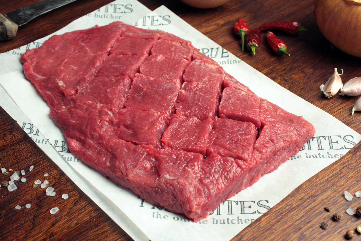 beef flat iron steak displayed on true bites greaseproof paper