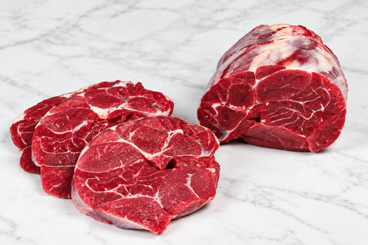 raw beef shin with slices on white counter tp