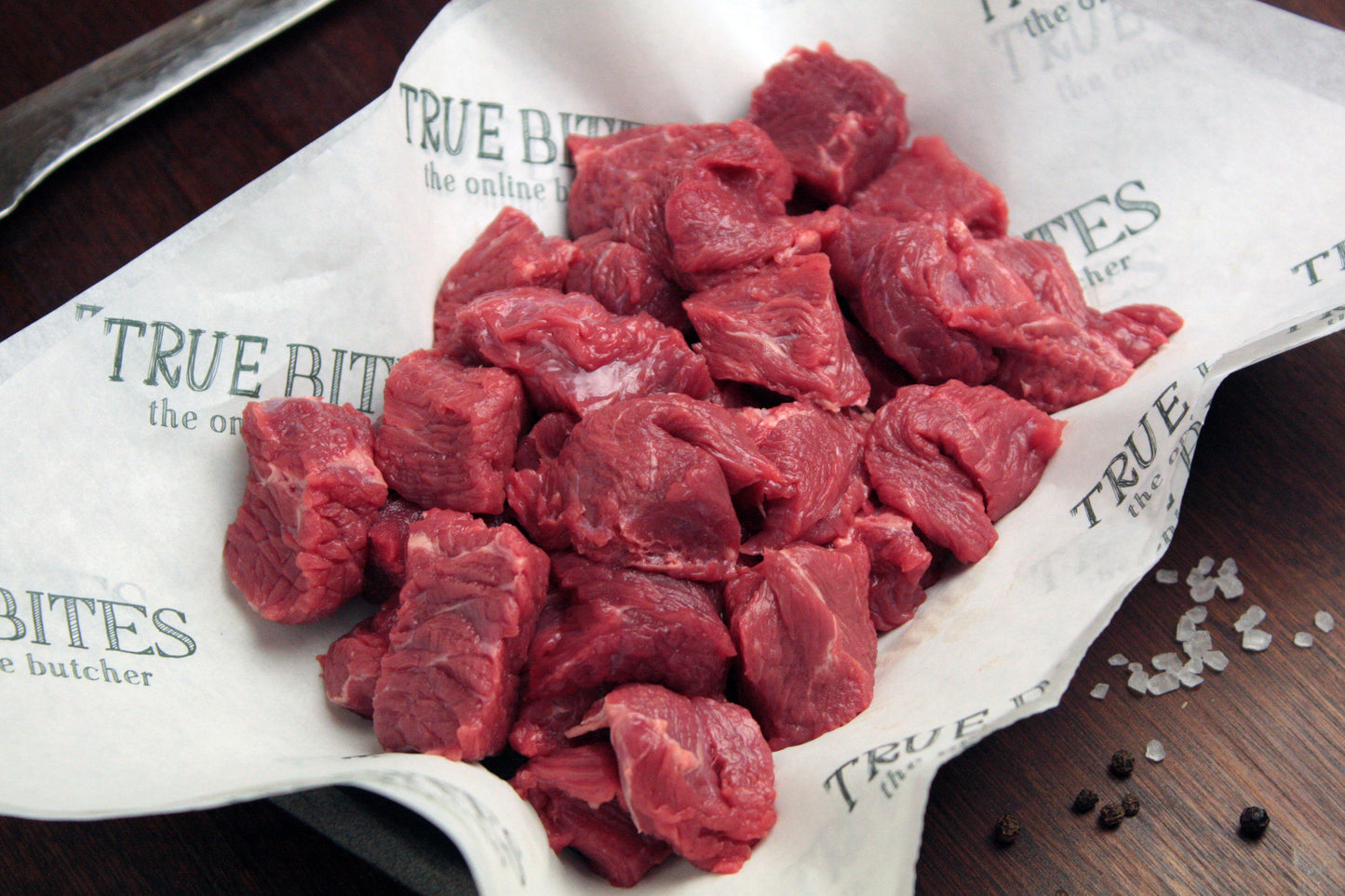 diced beef steak displayed on true bites greaseproof paper