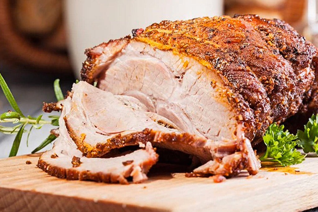 roasted pork shoulder on a wooden chopping board