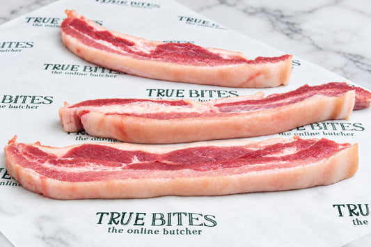 sliced pork belly on true bites greaseproof paper