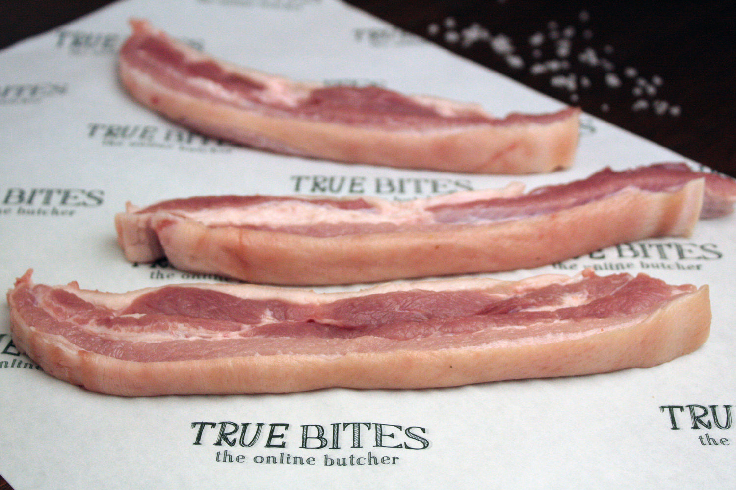 sliced pork belly on true bites greaseproof paper